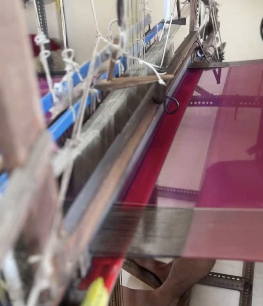 Weaver's hands on a traditional Maheshwari handloom in Maheshwar, India
